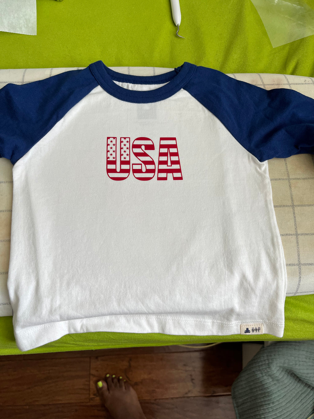 T-shirt with medallion size graphic on front & lettering on back