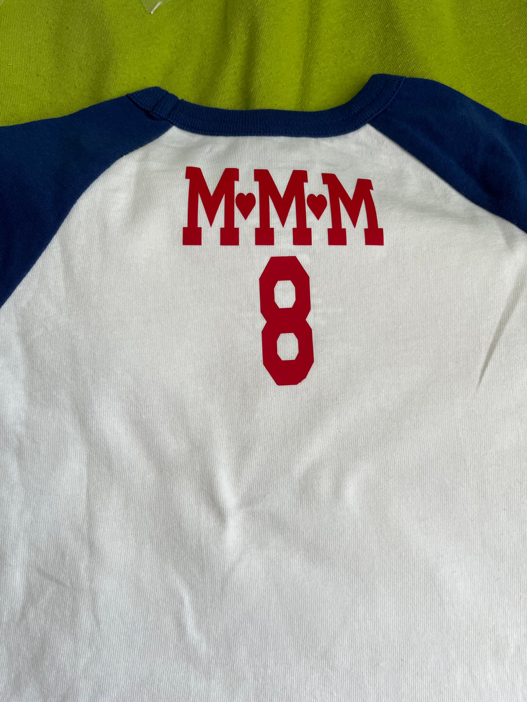 T-shirt with medallion size graphic on front & lettering on back