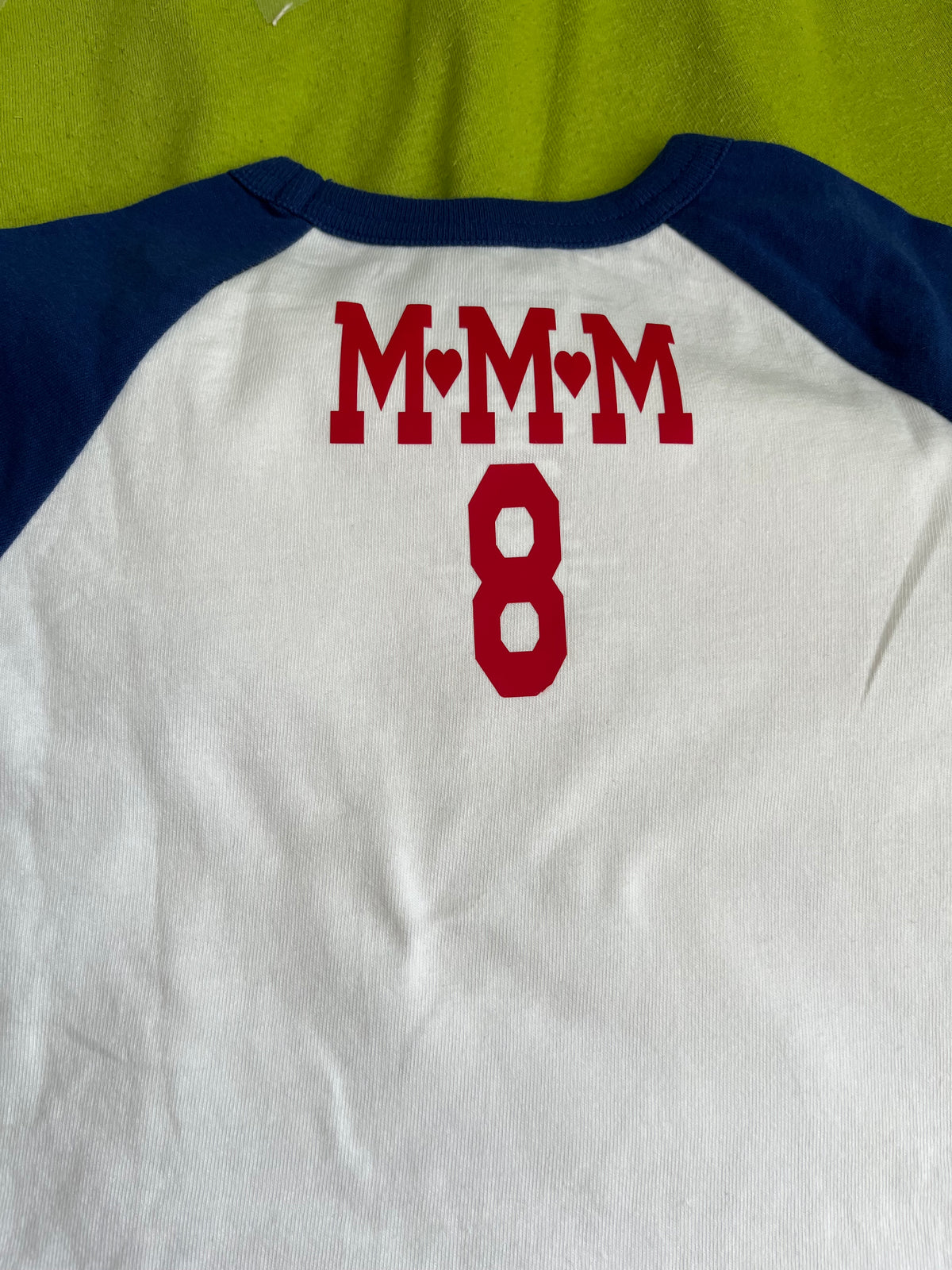 T-shirt with medallion size graphic on front & lettering on back